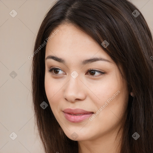 Joyful asian young-adult female with long  brown hair and brown eyes