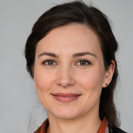 Joyful white adult female with medium  brown hair and brown eyes