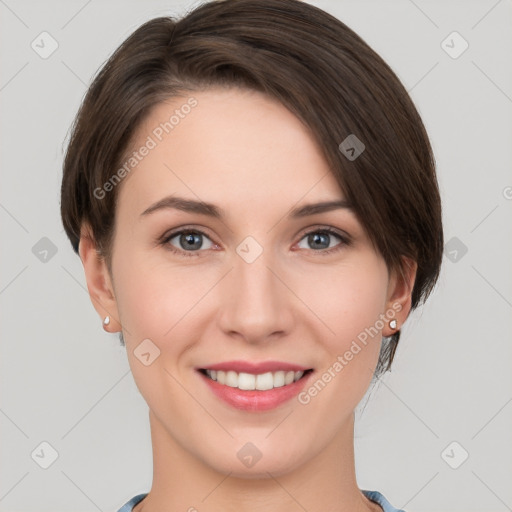 Joyful white young-adult female with short  brown hair and grey eyes