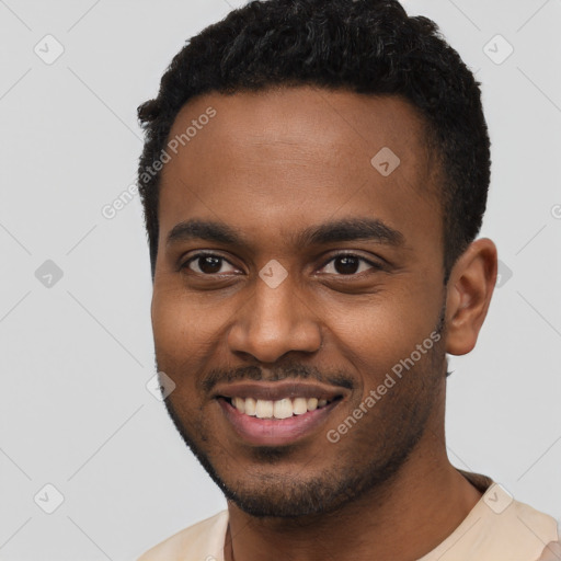 Joyful black young-adult male with short  black hair and brown eyes