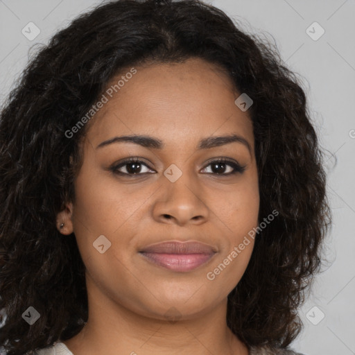 Joyful black young-adult female with long  brown hair and brown eyes