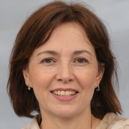 Joyful white adult female with medium  brown hair and brown eyes