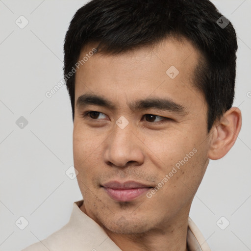 Joyful asian young-adult male with short  black hair and brown eyes