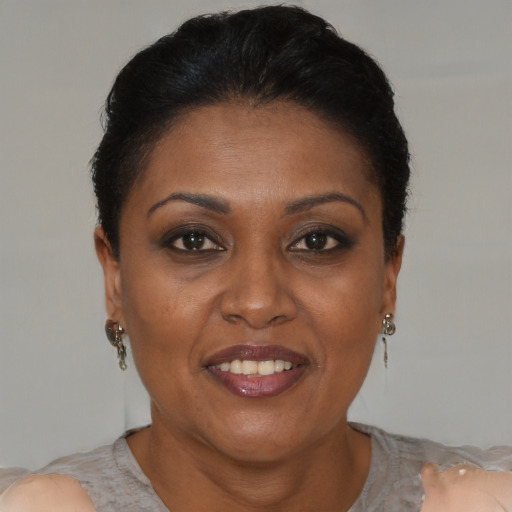 Joyful black adult female with short  brown hair and brown eyes