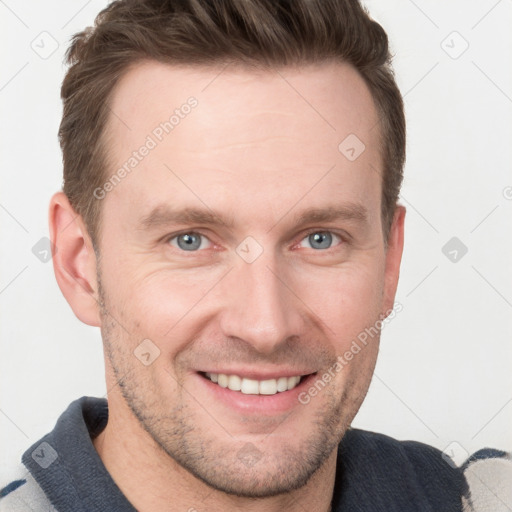 Joyful white young-adult male with short  brown hair and grey eyes