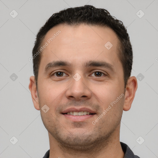 Joyful white young-adult male with short  black hair and brown eyes