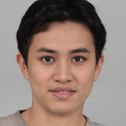 Joyful asian young-adult male with short  brown hair and brown eyes