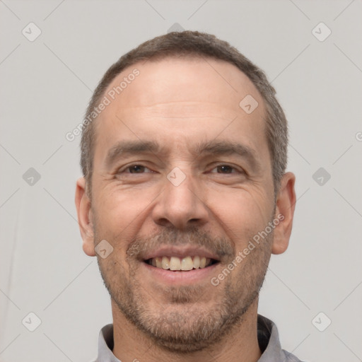 Joyful white adult male with short  brown hair and brown eyes