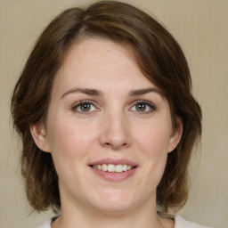 Joyful white young-adult female with medium  brown hair and green eyes