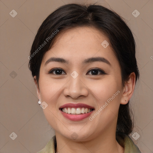 Joyful asian young-adult female with medium  brown hair and brown eyes