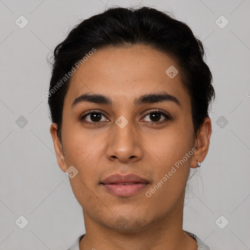 Joyful latino young-adult female with short  black hair and brown eyes