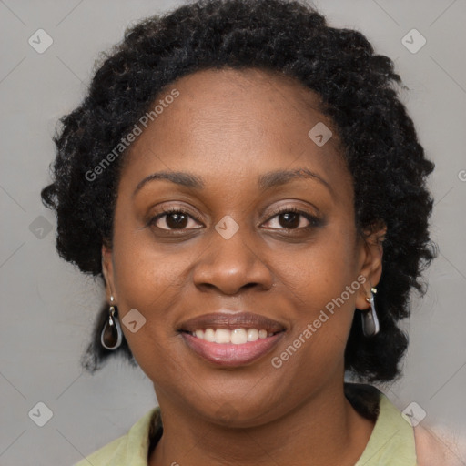 Joyful black young-adult female with long  brown hair and brown eyes