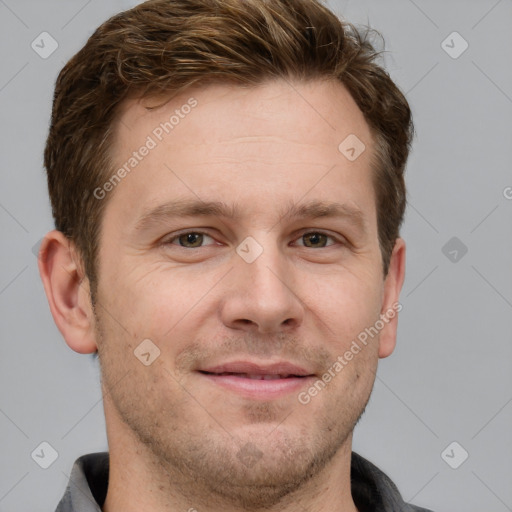 Joyful white adult male with short  brown hair and grey eyes