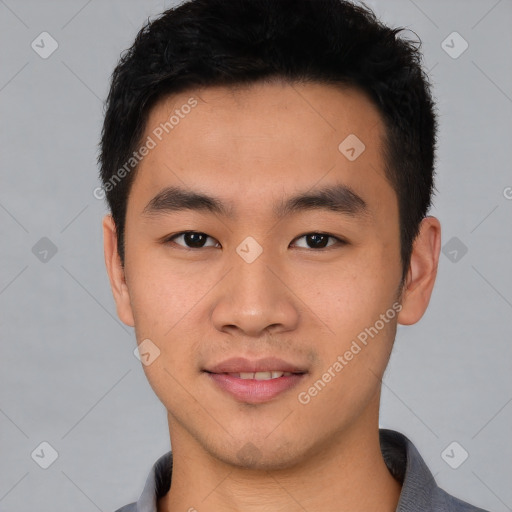 Joyful asian young-adult male with short  black hair and brown eyes