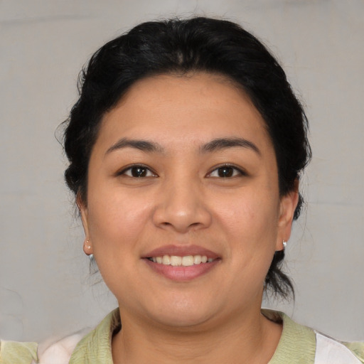 Joyful latino young-adult female with short  brown hair and brown eyes