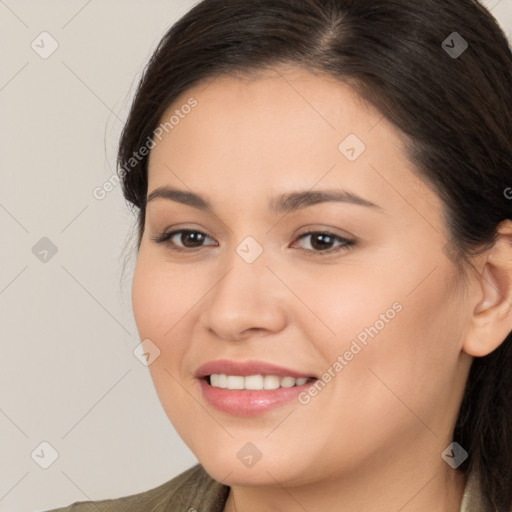 Joyful white young-adult female with long  brown hair and brown eyes