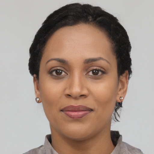 Joyful latino young-adult female with short  black hair and brown eyes