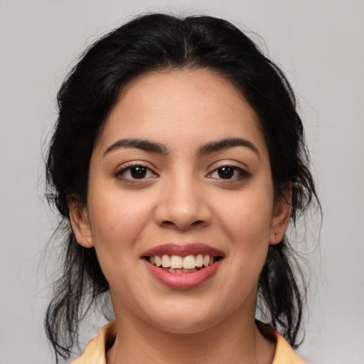Joyful latino young-adult female with medium  brown hair and brown eyes