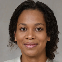 Joyful black young-adult female with medium  brown hair and brown eyes