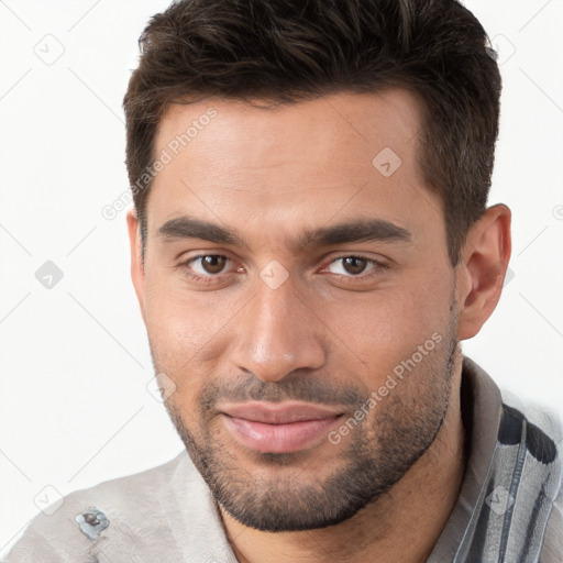 Joyful white young-adult male with short  brown hair and brown eyes