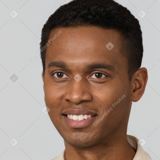 Joyful black young-adult male with short  brown hair and brown eyes