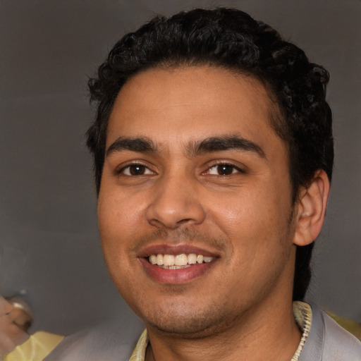 Joyful latino young-adult male with short  black hair and brown eyes