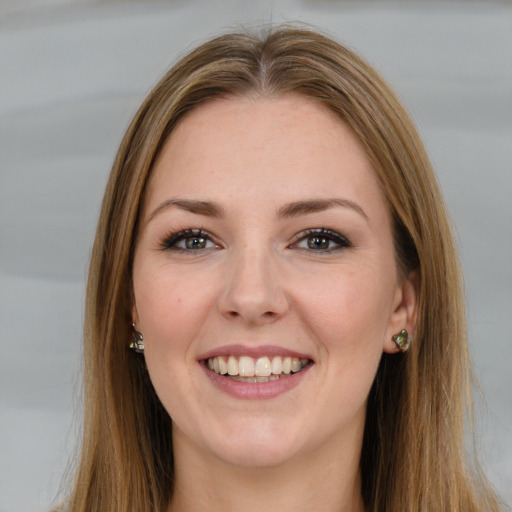 Joyful white young-adult female with long  brown hair and green eyes