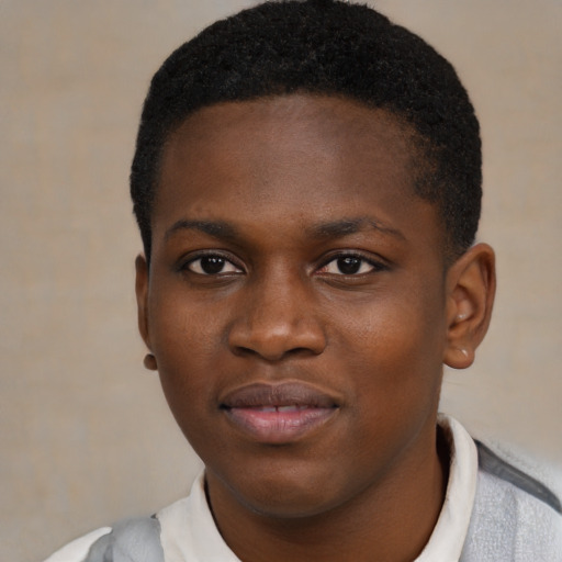Joyful black young-adult male with short  brown hair and brown eyes