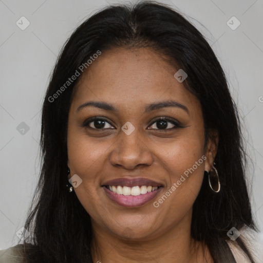 Joyful black young-adult female with long  brown hair and brown eyes