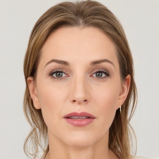 Joyful white young-adult female with medium  brown hair and grey eyes