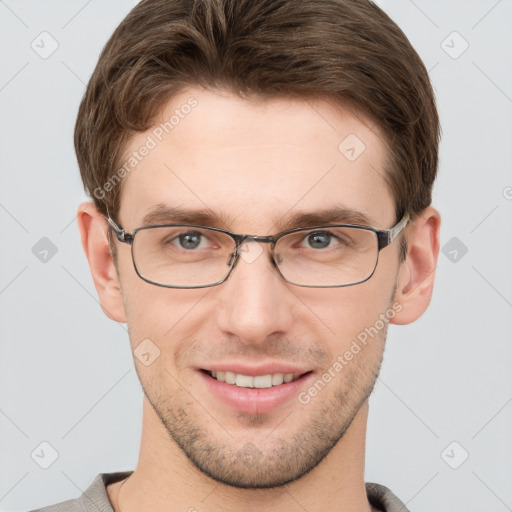 Joyful white young-adult male with short  brown hair and grey eyes