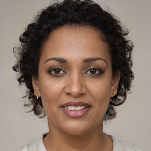 Joyful black young-adult female with short  brown hair and brown eyes