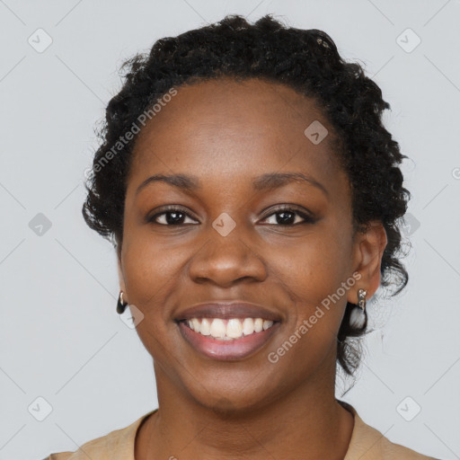 Joyful black young-adult female with long  black hair and brown eyes