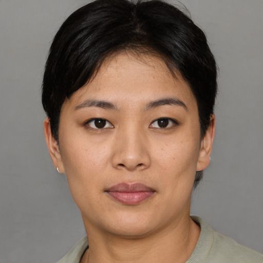 Joyful asian young-adult female with short  brown hair and brown eyes
