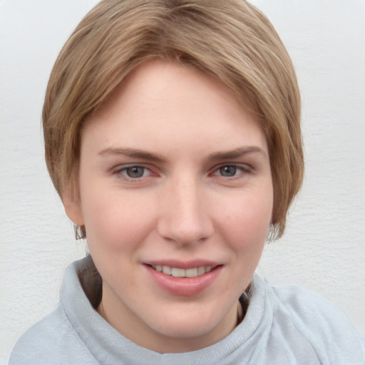 Joyful white young-adult female with short  brown hair and blue eyes