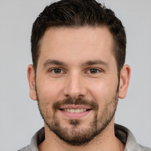 Joyful white young-adult male with short  brown hair and brown eyes