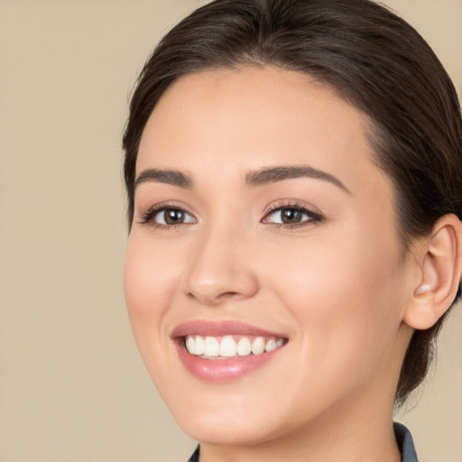 Joyful white young-adult female with medium  brown hair and brown eyes