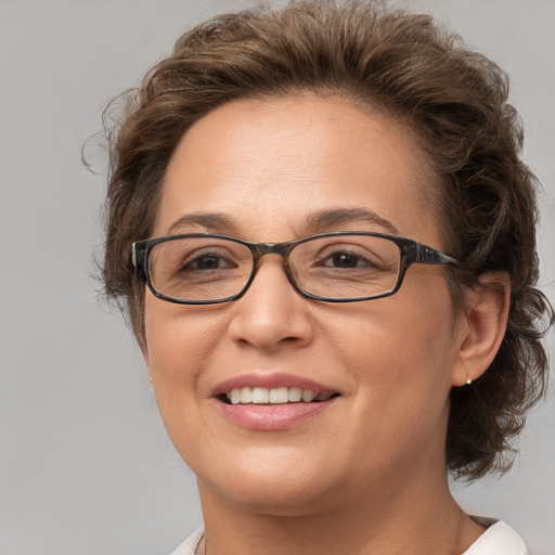 Joyful white adult female with medium  brown hair and brown eyes