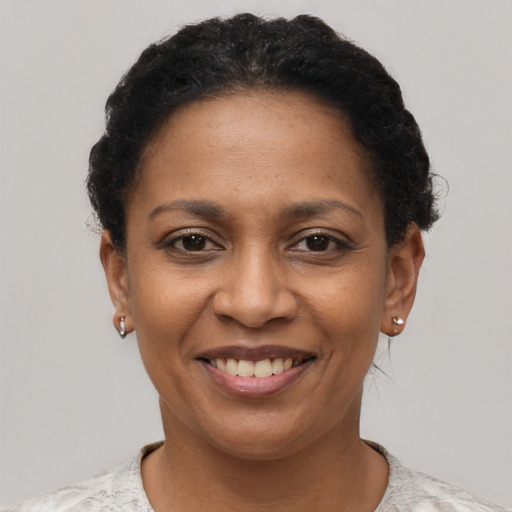 Joyful black adult female with short  brown hair and brown eyes