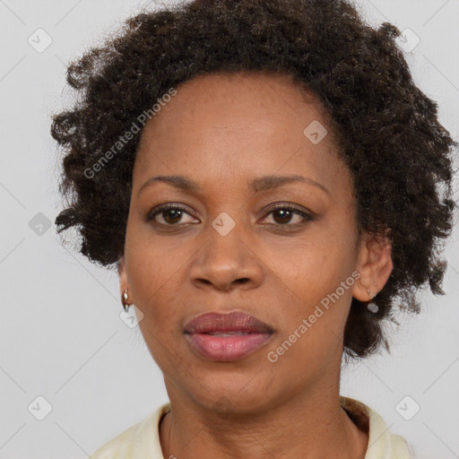 Joyful black adult female with short  brown hair and brown eyes