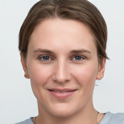 Joyful white young-adult female with short  brown hair and grey eyes