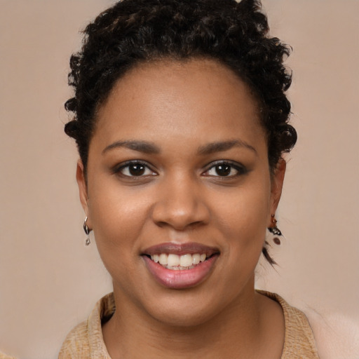Joyful black young-adult female with short  brown hair and brown eyes
