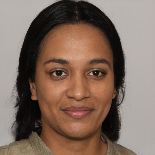 Joyful black adult female with medium  black hair and brown eyes