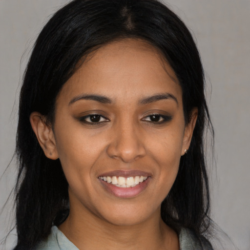 Joyful latino young-adult female with long  black hair and brown eyes