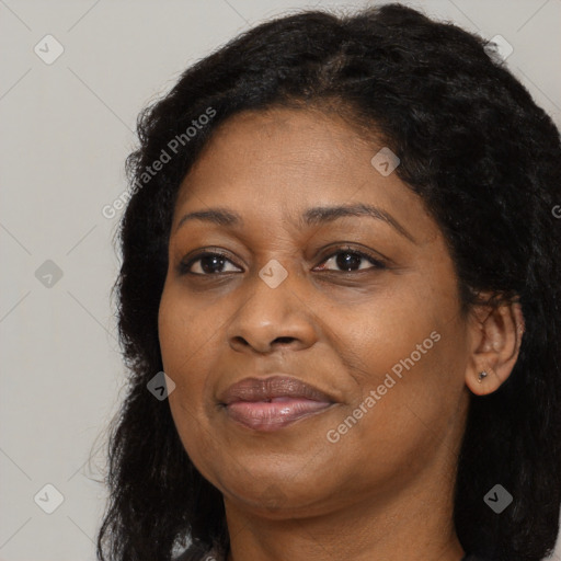 Joyful black adult female with long  brown hair and brown eyes