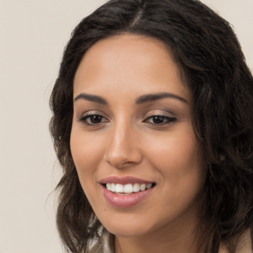 Joyful white young-adult female with long  brown hair and brown eyes