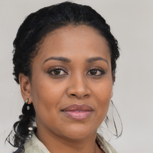 Joyful black young-adult female with medium  brown hair and brown eyes