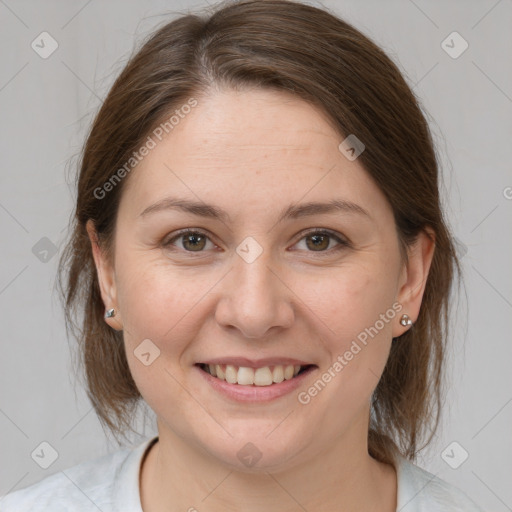 Joyful white adult female with medium  brown hair and grey eyes