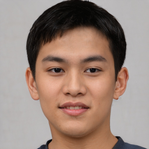 Joyful asian young-adult male with short  black hair and brown eyes