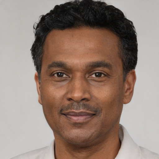 Neutral latino adult male with short  black hair and brown eyes